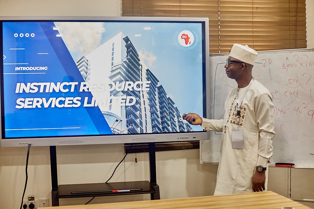 A facilitator presenting an introductory slide for Instinct Resource Services Limited during a training session
