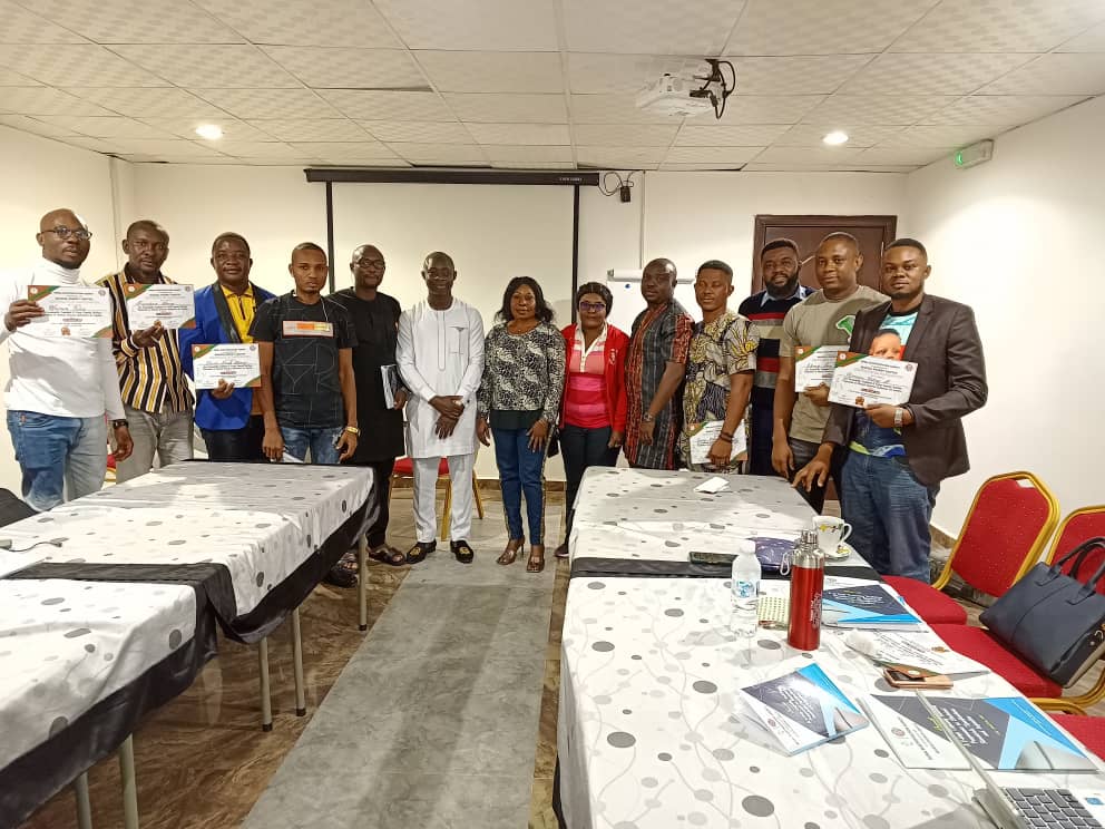 The Managing Director , other facilitators and participants of a training session organized for the Rural Electrification Agency,  with their certificates of participation .