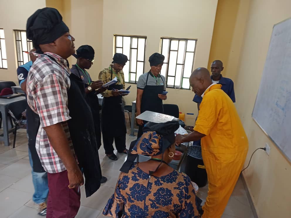 Participants actively engaged in a paint making practical session during a Pre- Retirement Training organized for the Nigeria Airspace Management Agency